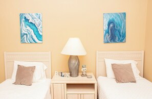 A hotel room with two beds, a nightstand with a lamp, and two abstract paintings on the walls. - Magnolia Place 4665-301 (Myrtle Beach)
