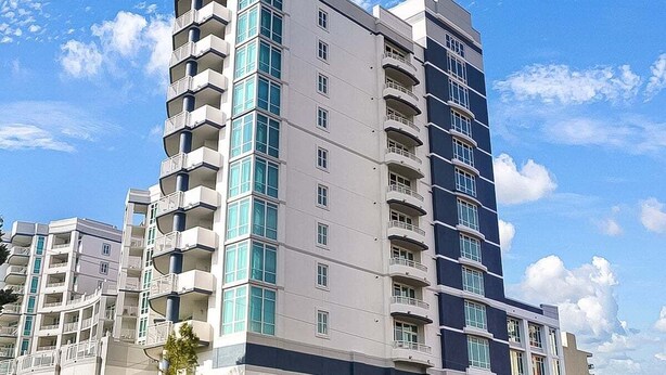 A multi-story residential building with balconies, large windows, and a modern architectural design. - Horizon 701 (Myrtle Beach)