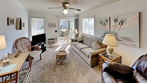 A living room with a sofa, a television, a ceiling fan, and a window with blinds. - A Place at the Beach IV G143 (Myrtle Beach)