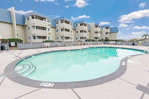 A swimming pool with a 3 FT depth marker, surrounded by a fence and lounge chairs. - A Place at the Beach IV G143 (Myrtle Beach)