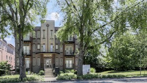 A multi-story building with a symmetrical facade, large windows, and a central entrance. - Pink Party Nashville-near Music Row, Free Parking (Nashville)