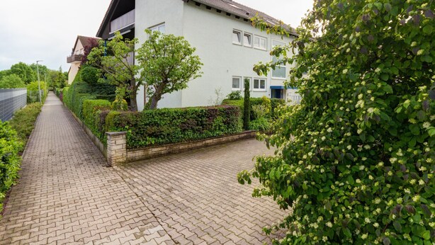 A modern two-story house with a paved driveway and a well-maintained garden. - ApartmentmitAusblick by Interhome (Wörth)