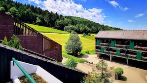 A rural setting with a building that has a sloped roof and a balcony with flower boxes. - Schwarzwald Loft mit Schwimmbad und herrlicher Aussicht by Interhome (Sasbachwalden)