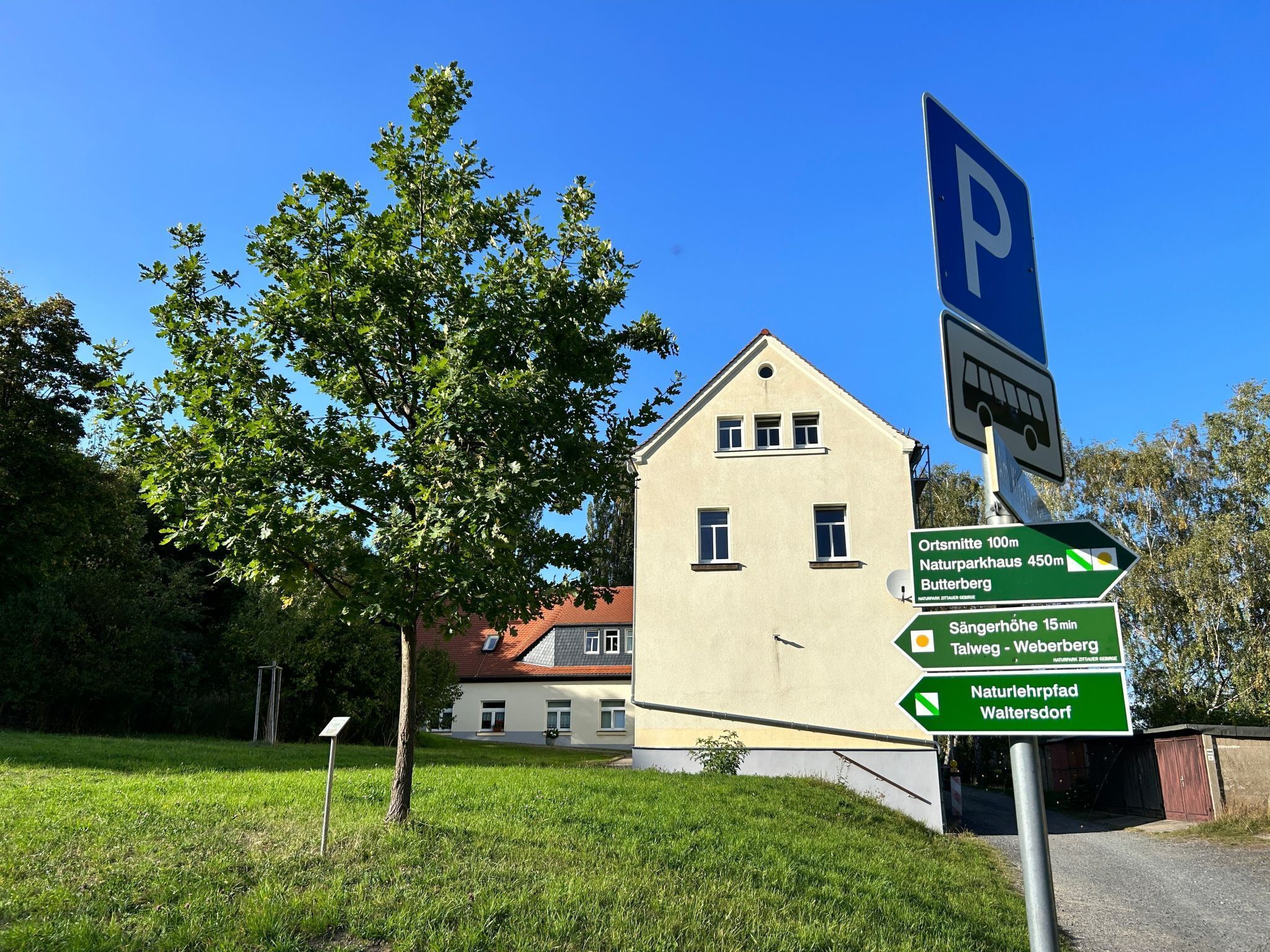 A building with a sign indicating directions to nearby locations.