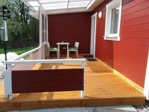 A wooden deck with a bench, a small table, and two chairs. - Beerberg by Interhome (Suhl)