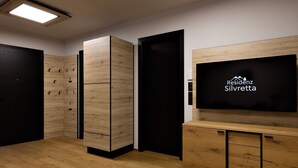 Una habitación de hotel moderna con televisión de pantalla plana, muebles de madera e iluminación en el techo.