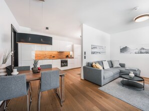 A modern apartment with a kitchen, dining area, and living room. - Charmantes Apartment in der Residenz Silvretta by Interhome (See)