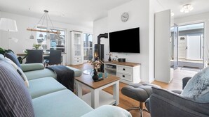 A modern living room with a sofa, a coffee table, a TV, and a fireplace. - Maltes-Ostseekoje by Interhome (Hasselberg)