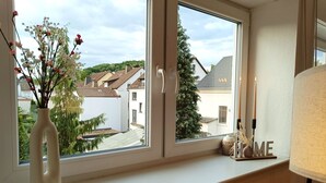 A room with a large window, a vase with flowers, a "HOME" sign, and a lamp. - am Ruhrtalradweg Arnsberg by Interhome (Arnsberg)