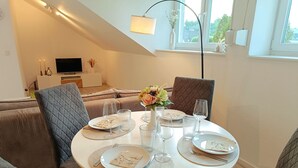 A dining area with a round table set for four, surrounded by cushioned seating. - am Ruhrtalradweg Arnsberg by Interhome (Arnsberg)
