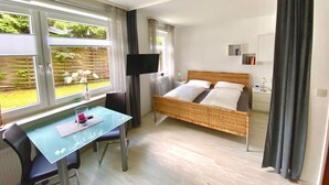 A bedroom with a bed, a desk, and a TV. - für zwei Personen, WLAN vorhanden by Interhome (Braunlage)