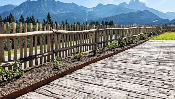 A wooden deck with a metal railing, leading to a mountainous landscape. - Haus Schönblick by Interhome (Tannheim)