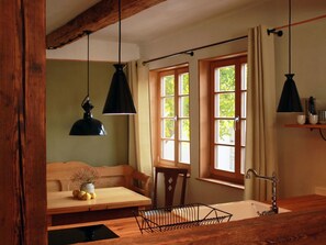 A cozy room with a wooden bench, a sink, and a window with curtains. - für 2 Personen  + 2 Kinder ca. 70 m² in Quedlinburg, Harz (Unterharz) by Interhome (Quedlinburg)