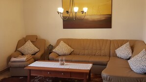 A living room with a sofa set, a coffee table, and a chandelier. - Elbufer 4C by Interhome (Marschacht)