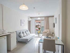 A modern, well-lit apartment with a kitchenette, a dining area, and a living space. - Gemütliche kleine Wohnung by Interhome (Ayia Napa)