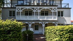 A two-story building with a balcony, a door labeled "Villa Bernstein," and a brick pathway leading to the entrance. - Bernstein by Interhome (Binz)