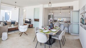 A modern apartment with a dining area, kitchen, living room, and a balcony. - 3-Schlafzimmer-Villa mit privatem Pool im Zentrum by Interhome (Protaras)