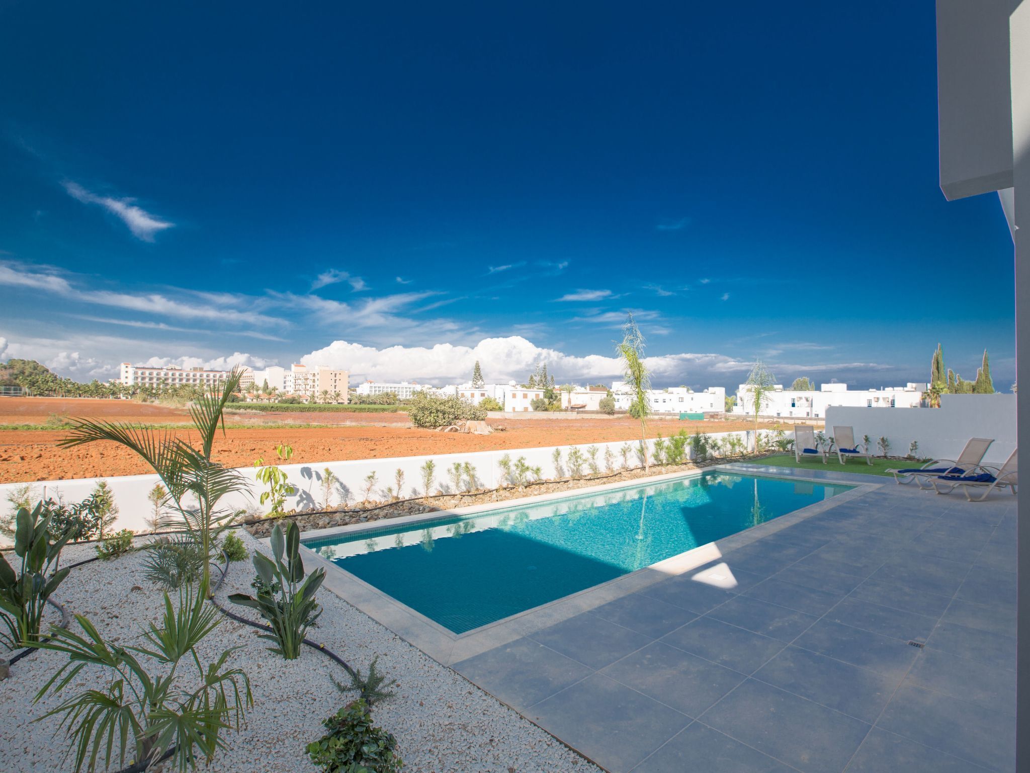 A swimming pool with a view of buildings in the background.