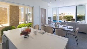 A modern dining area with a large table, chairs, and a view of a swimming pool. - Luxuriöse Villa Vie Bleu by Interhome (Protaras)