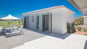 A modern house with a tiled roof, a patio with sun loungers, and a clear blue sky. - in Ayia Napa mit großem Patio by Interhome (Ayia Napa)