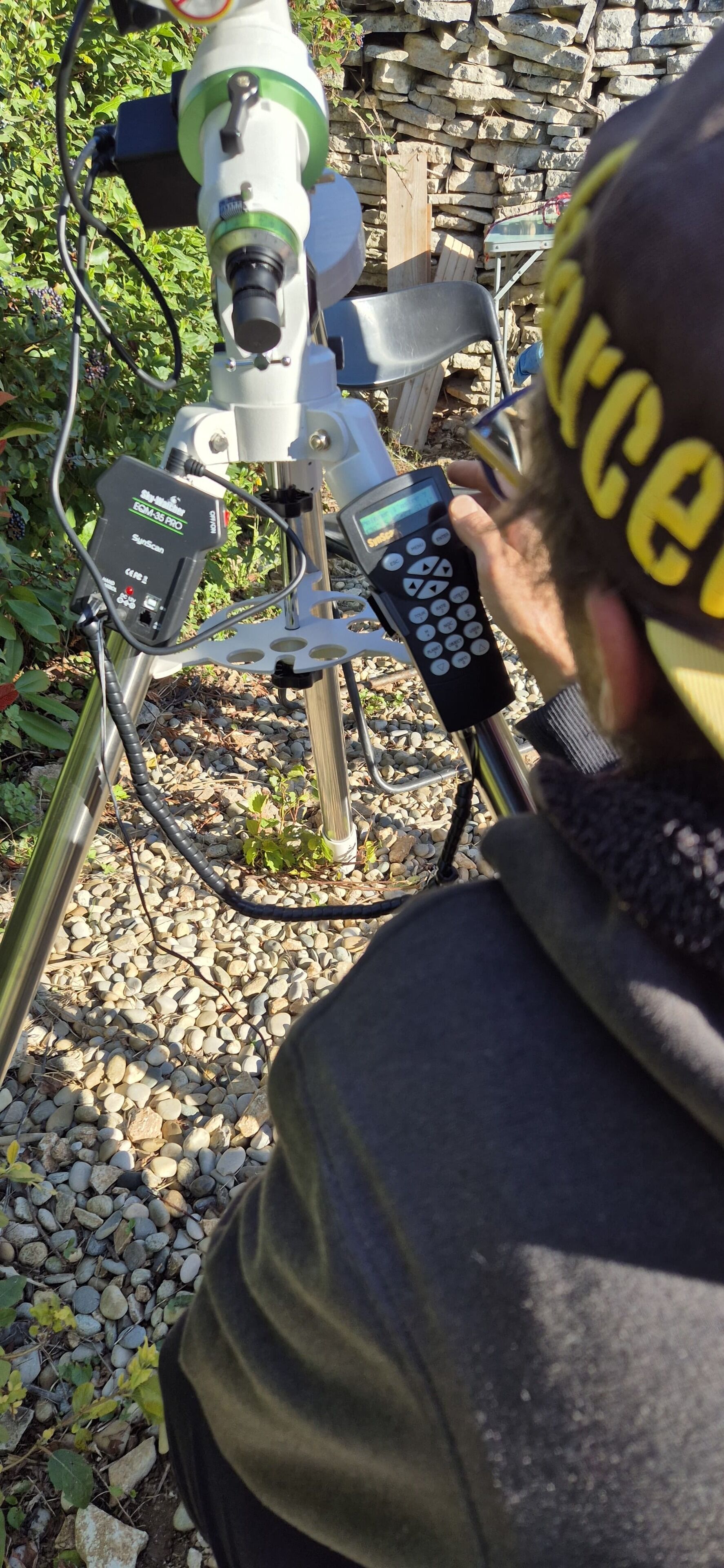 A person operating a piece of machinery with a control panel and a digital screen.