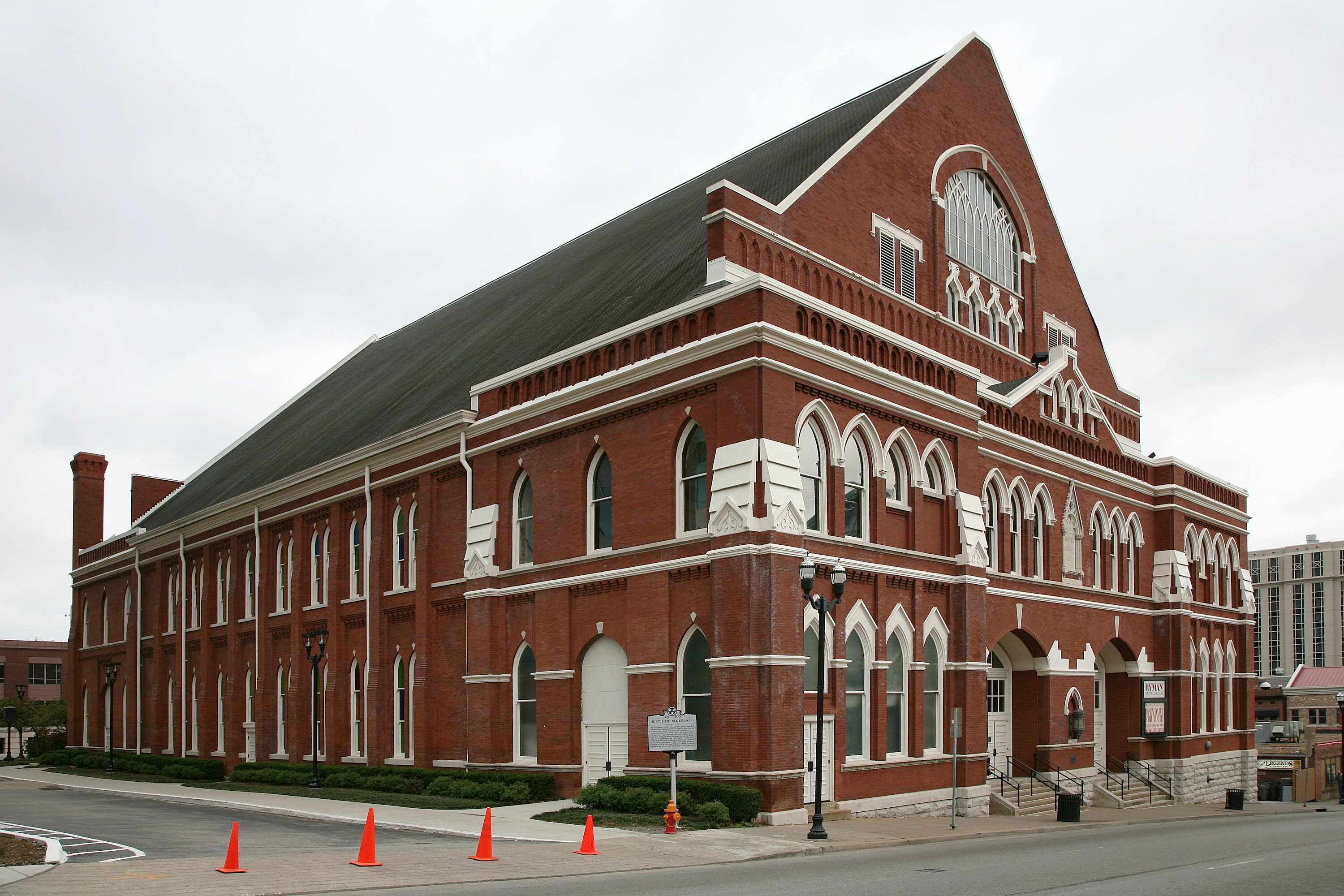 A large brick building with arched windows and a prominent steeple.