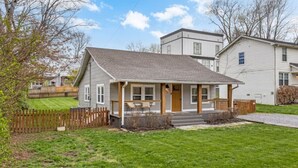 A single-story house with a front porch, a fenced yard, and a well-maintained lawn. - Space Cowboy - Firepit, Huge Yard, Close2downtown (Nashville)