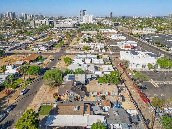An aerial view of a residential area with multiple buildings, roads, and a few vehicles. - Central Phoenix Casita Unit C (Phoenix)
