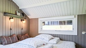 A bedroom with a bed, pillows, a window, and wall-mounted lights. - 3 bedroom nice home in Haarby (Haarby)