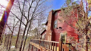 A rustic log cabin with a wooden deck and a chimney, surrounded by trees. - Moonlit Mountain: A peaceful escape to reconnect, unwind, and breathe deep (Ellijay)
