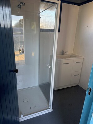 Shower, hair dryer, towels, toilet paper