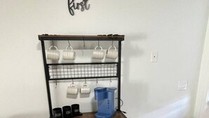 A kitchen area with a coffee maker, mugs, and a trash can. - Blue&pink#3 Pool Centralphx (Phoenix)