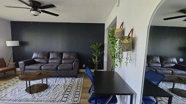 A living room with a sofa, coffee table, and chairs, a ceiling fan, and a plant. - Blue&pink#3 Pool Centralphx (Phoenix)