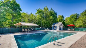 A rectangular swimming pool with a metal ladder, surrounded by lounge chairs and a covered pavilion. - Mt Green 2-e06 (Killington)