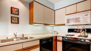 A compact kitchen with a dishwasher, stove, microwave, and double sink. - Sunrise - W Glade J-1 (Killington)