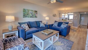 A modern living room with two sofas, a coffee table, and a ceiling fan. - 427 El Matador (Fort Walton Beach)
