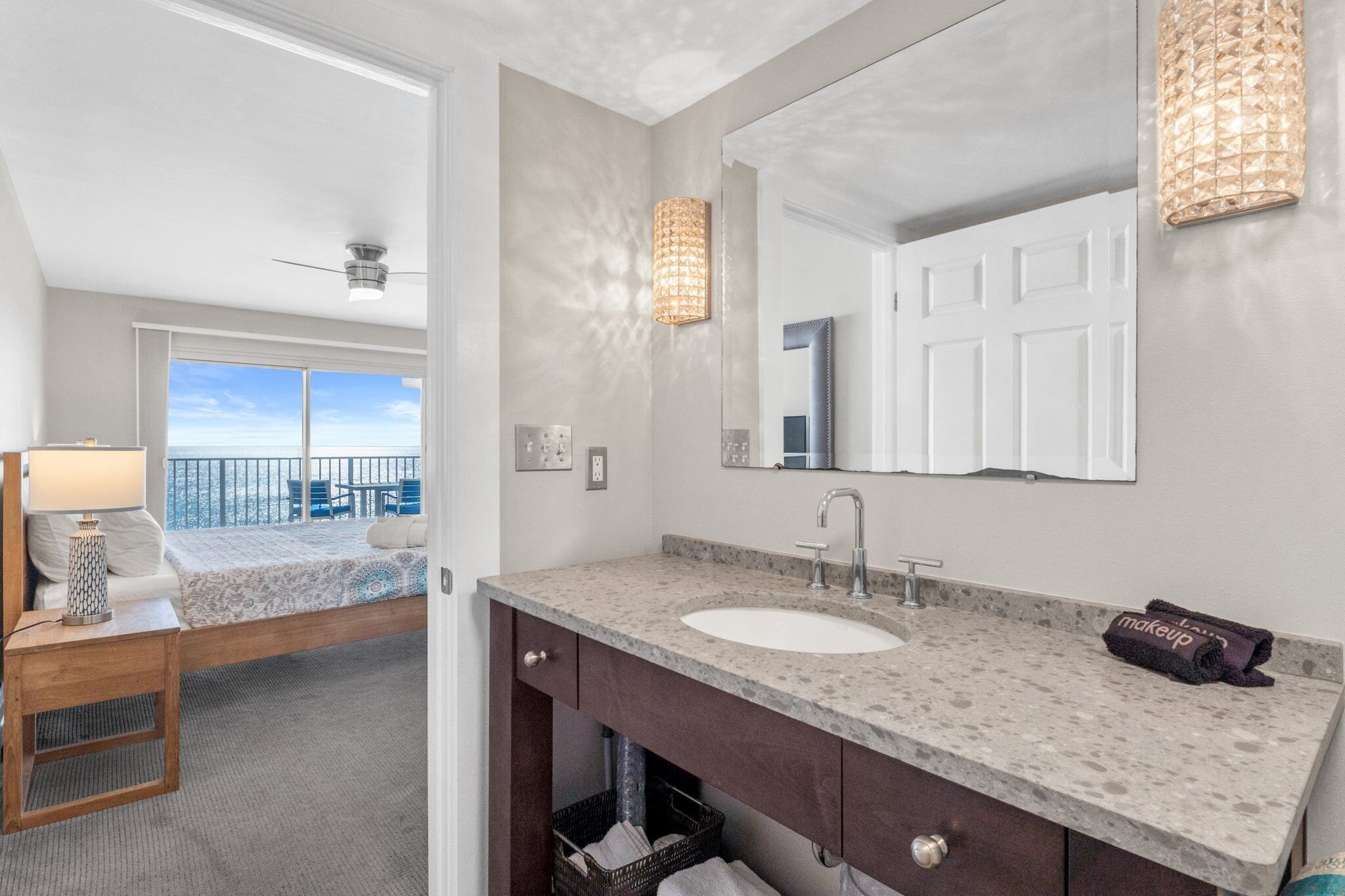 A modern bathroom with a large mirror, a sink, and a vanity.