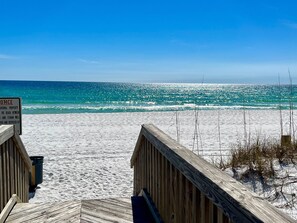 A wooden boardwalk leading to a beach with a sign indicating it is private property. - Emerald Isle 102 - The Seashell (Fort Walton Beach)