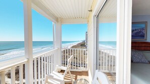 A balcony with white railings overlooking a beach and ocean. - Ambassador Villas 403 (North Myrtle Beach)