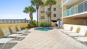 A rooftop pool area with lounge chairs, a small pool, and palm trees. - Pelican Isle 113 - Salty Seahorse (Fort Walton Beach)