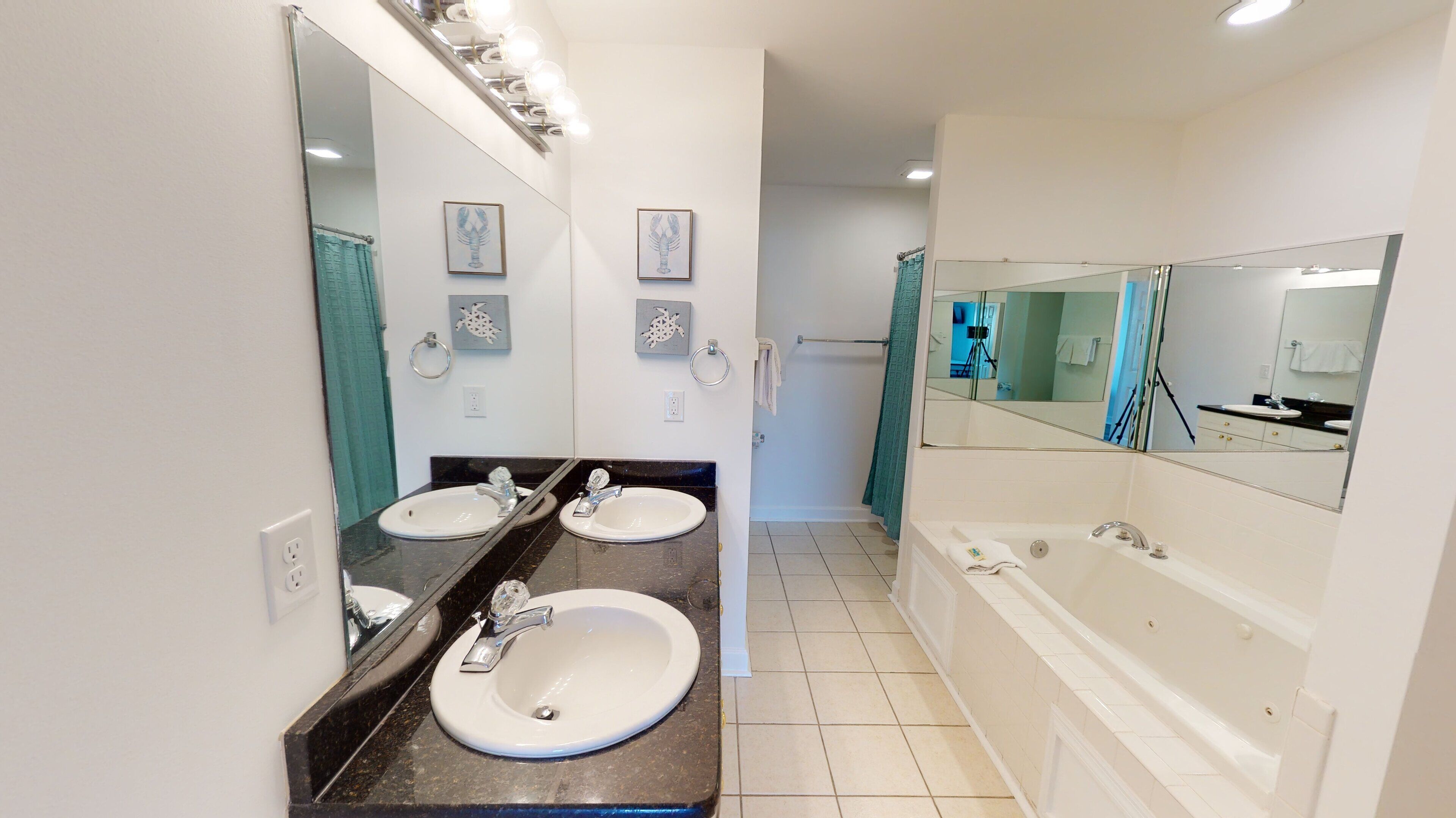 A modern bathroom with two sinks, a large mirror, and a bathtub.