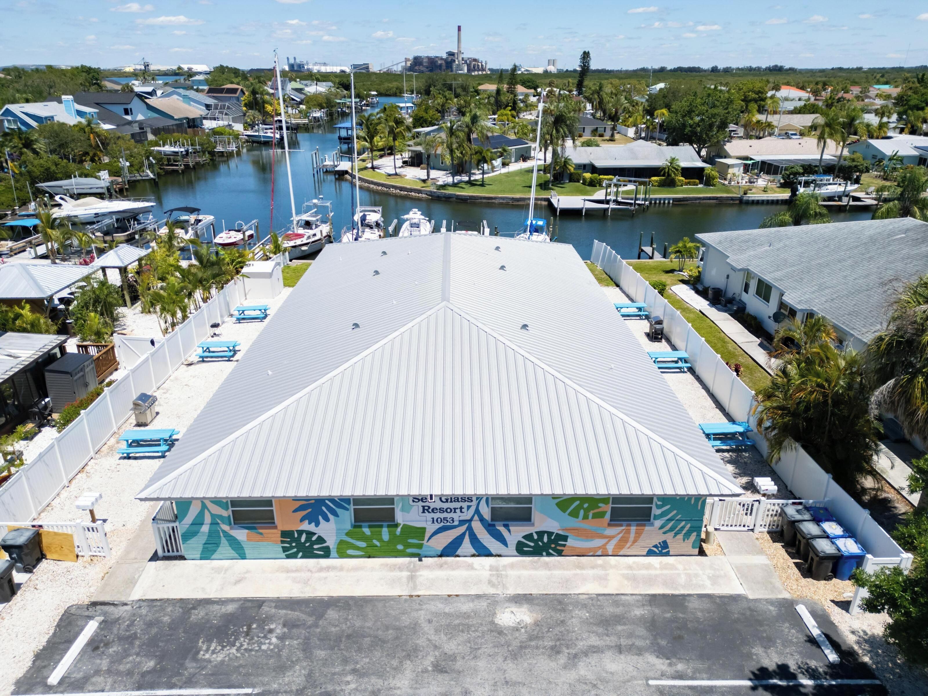 A resort with a large parking area, a marina with boats, and a view of the surrounding area.