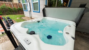A hot tub with a control panel, surrounded by a deck and a wooden fence. - Rare Exclusive Retreat Private Hot Tub King Bed (Arlington)