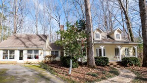 A two-story house with a porch and a driveway leading to the front door. - 371 Mountain Hill Rd, Fortson (Hamilton)