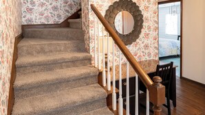 A carpeted staircase with wooden railings and a decorative mirror on the wall. - 371 Mountain Hill Rd, Fortson (Hamilton)