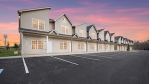 A row of single-story buildings with a parking lot in front. - Legacy Executive Retreat (Clarksville)