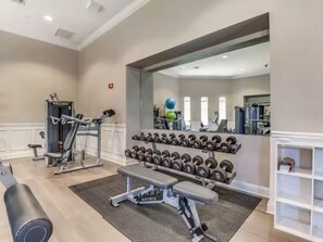 A gym with weightlifting equipment, dumbbells, and benches. - Epic Universe, Vista Cay Resort Orlando, 3BR 3.5BA (Orlando)