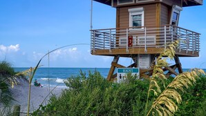 A lifeguard tower with a sign indicating 'BEACHES' and a 'TOWER 3' sign. - Seaside Escape (Bradenton Beach)