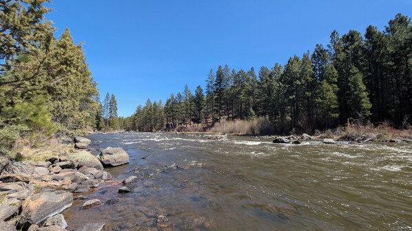 A river flowing through a forest with rocks and trees. - Mt Bachelor Village 332 A SR (Bend)