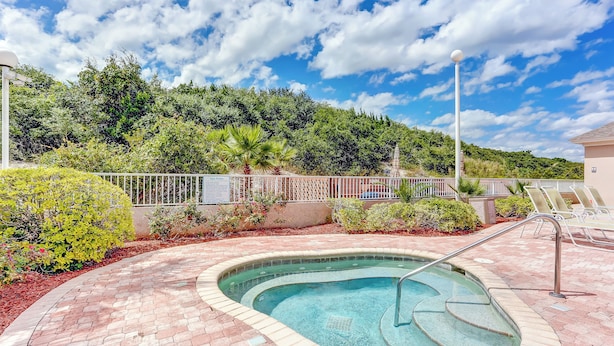 A swimming pool with a brick border, surrounded by a fence and greenery, with a clear sky above. - 1 Block From the Beach, Next to Ft Clinch State Park and 2 Miles From Historic Centre Street (Fernandina Beach)